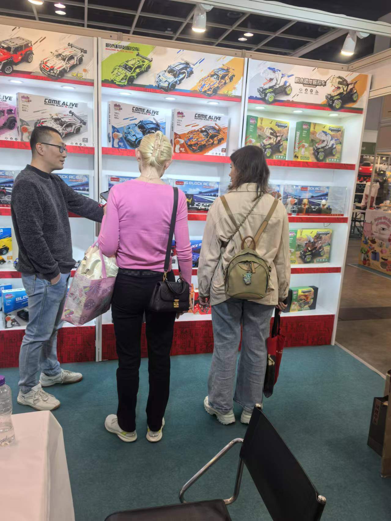 Toy buyers and sourcing staff comparing product samples at a trade show